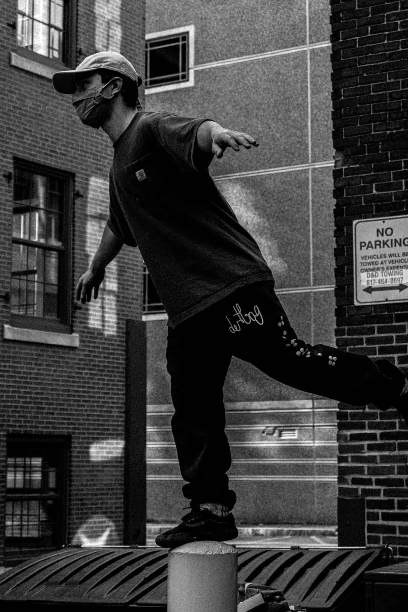 Petros balancing on a foothold in black and white