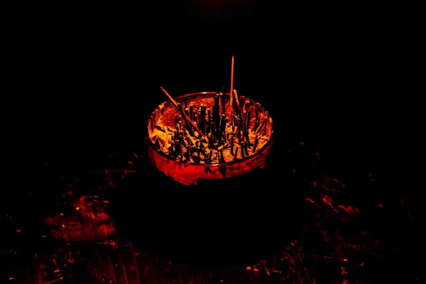 Candle turned into an incense holder bathed in warm light