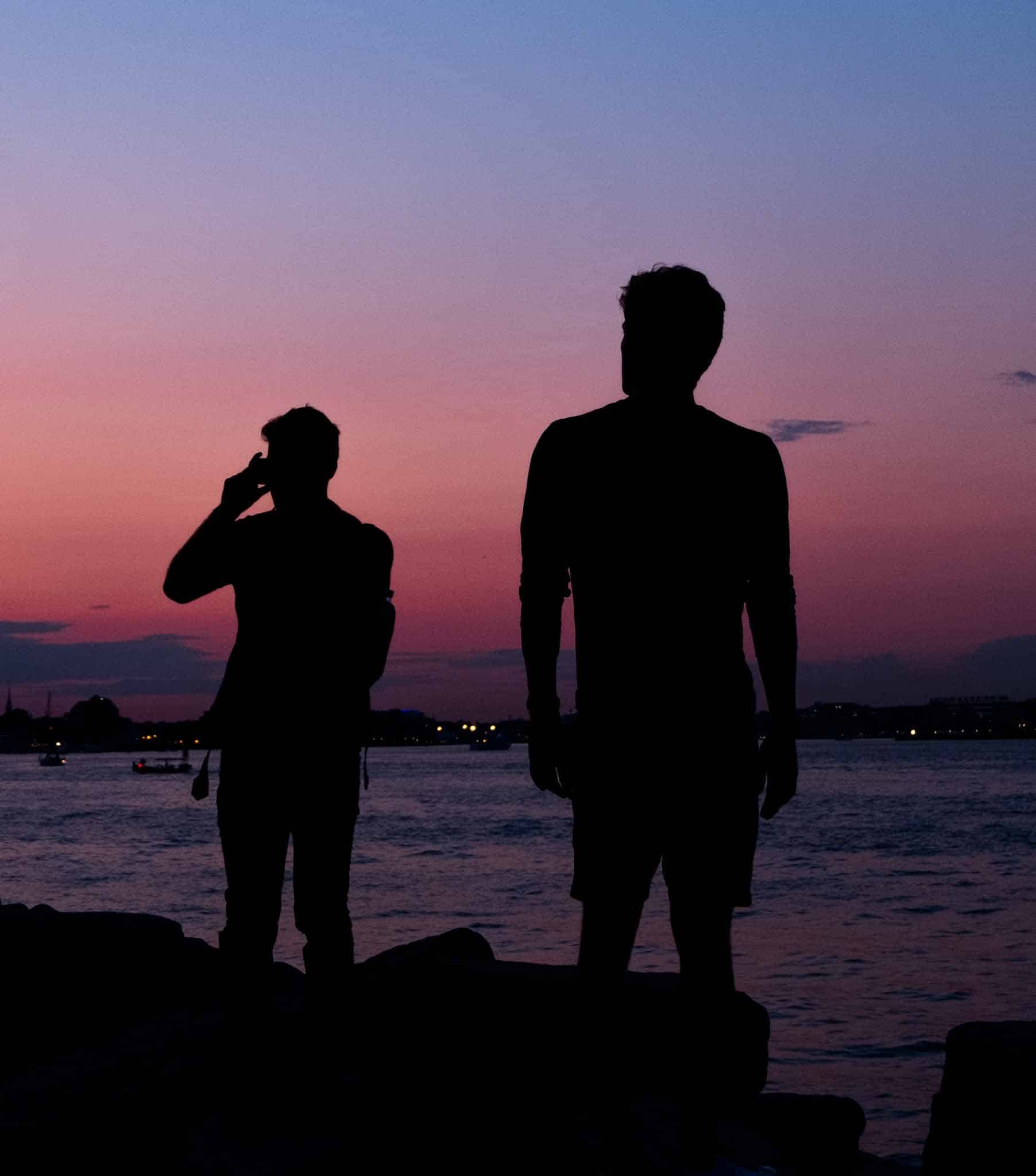 Gabe and Kabir looking out over the water at sunset