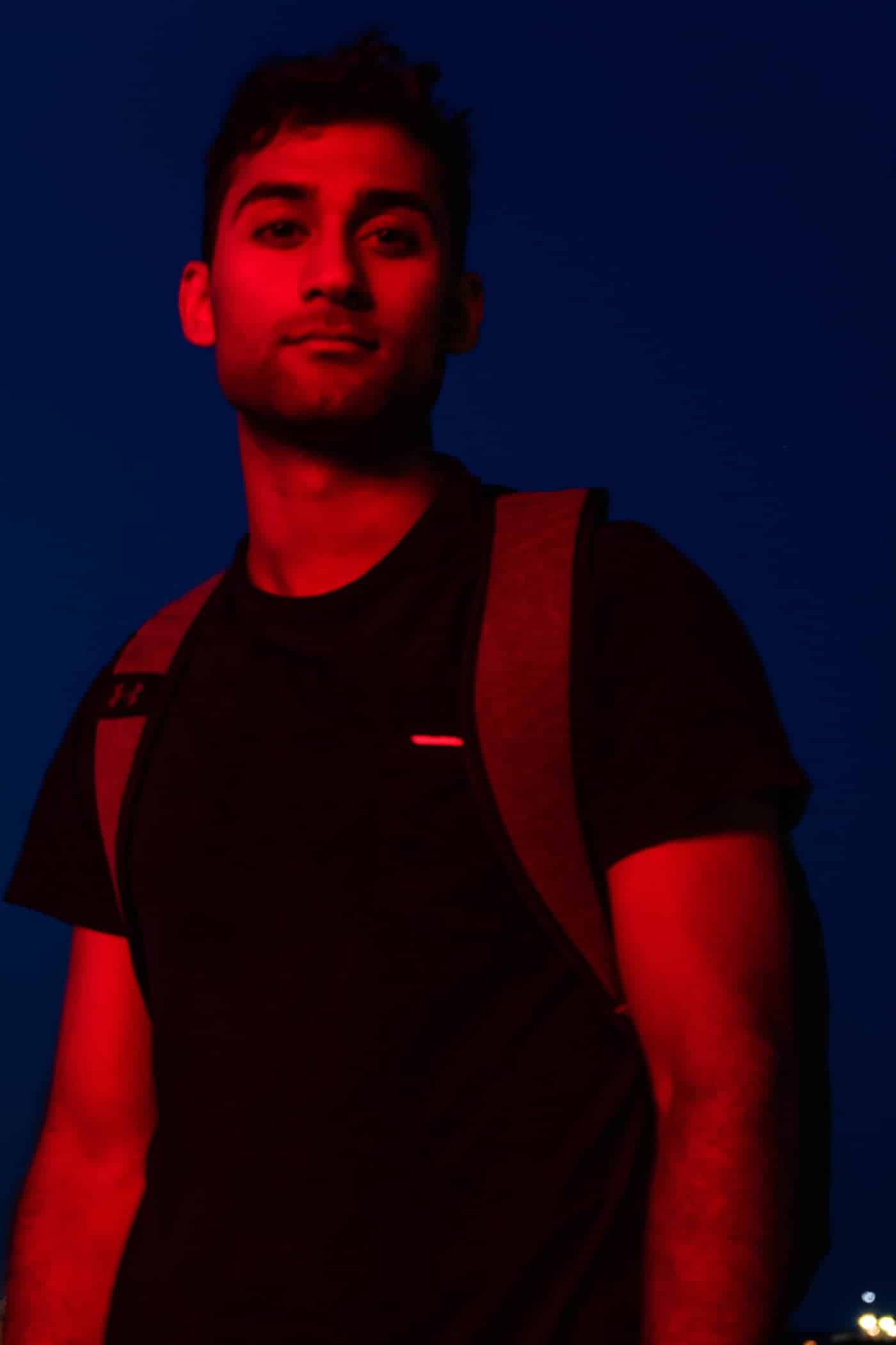 Kabir in a black t-shirt in red lighting